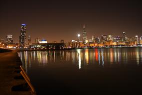 chicago night is reflected in lake michigan