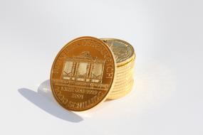 stack of gold coins on the white