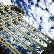 Beautiful building with the reflections of the beautiful blue sky with white clouds, in the windows