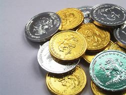 Colorful, shiny, metal coins at gray background