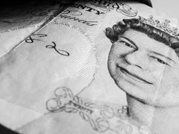 Black and white photo of the Banknote with the portrait of the Queen of United Kingdom