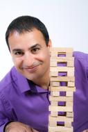 handsome man with stack of wooden bars