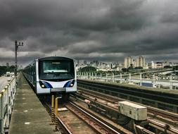 Train on the railways, among the city, under the cloudy sky, in Brazil