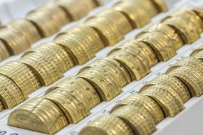 gold coins stacked in a box