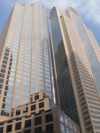 Shiny office buildings in Dallas, Texas, USA, in sunlight, under the blue sky with clouds