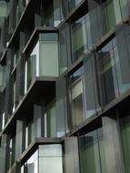 Close-up of the shiny, glass building in the city, in light