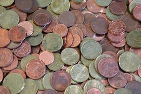 Close-up of the pile of the beautiful and colorful, patterned, shiny coins