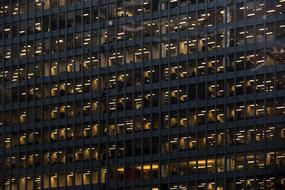 light in the windows of an office building at night