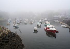 boats at ocean at fog