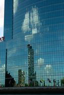 reflection of skyscrapers in the facade of the building