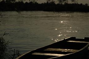 wooden boat on the river bank on a sunny day