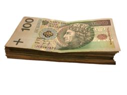 Close-up of the stack of the beautiful and colorful banknotes with the portrait and patterns, at white background
