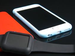 white smartphone and iwatch on the table