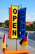 colorful banners with open lettering over german flags