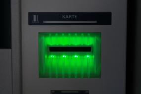 Close-up of the ATM with card slot with green light