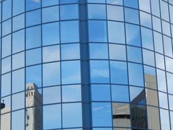 mirror reflection of skyscrapers in the facade of the building