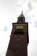 tower near the temple under white clouds