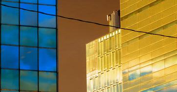 Colorful, shiny buildings with reflections of the sky, in the city