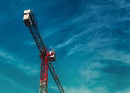 Close-up of the colorful crane, under the beautiful, blue sky with clouds