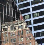 reflections in the glass facade of a corner building