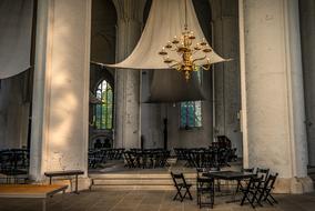 crown chandelier above dining tables in gothic interior