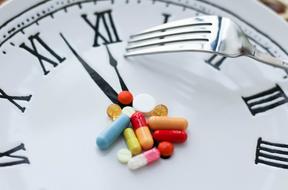medicines and fork on clock face, Health, concept