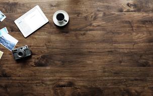 coffee and vintage photo camera on Wooden Table