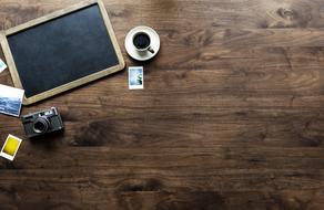 Wooden Table and camera and cup