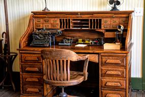 vintage wood writing desk with typewriter