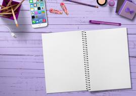 smartphone, notebook and pen on a purple table