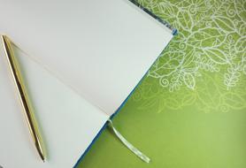 golden ball pen on blank notebook