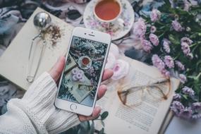 girl taking photo of still life with Smartphone