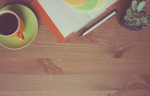Coffee and Notebook on Wooden desk
