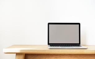 laptop with Empty screen on wooden table