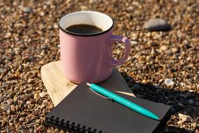 Notebook Pen and pink cup