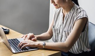 Adult woman works at laptop