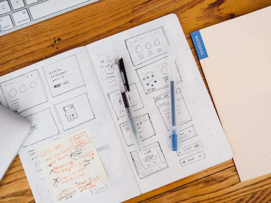 journals with drawings on wooden desk