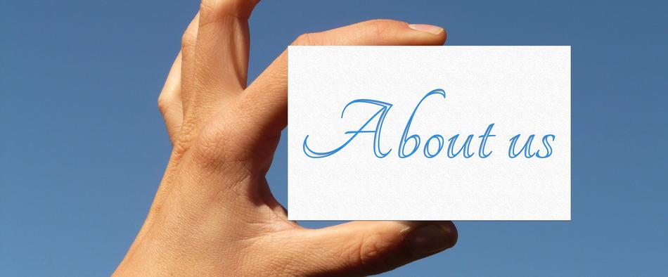 Blue and white 'About Us' card hand at blue sky background