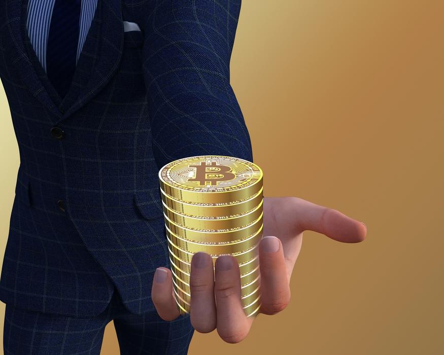 stack of bitcoins on businessmanâs hand, digital art