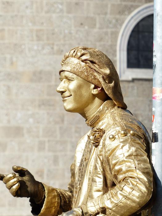 Beautiful, glossy golden street pantomime artist