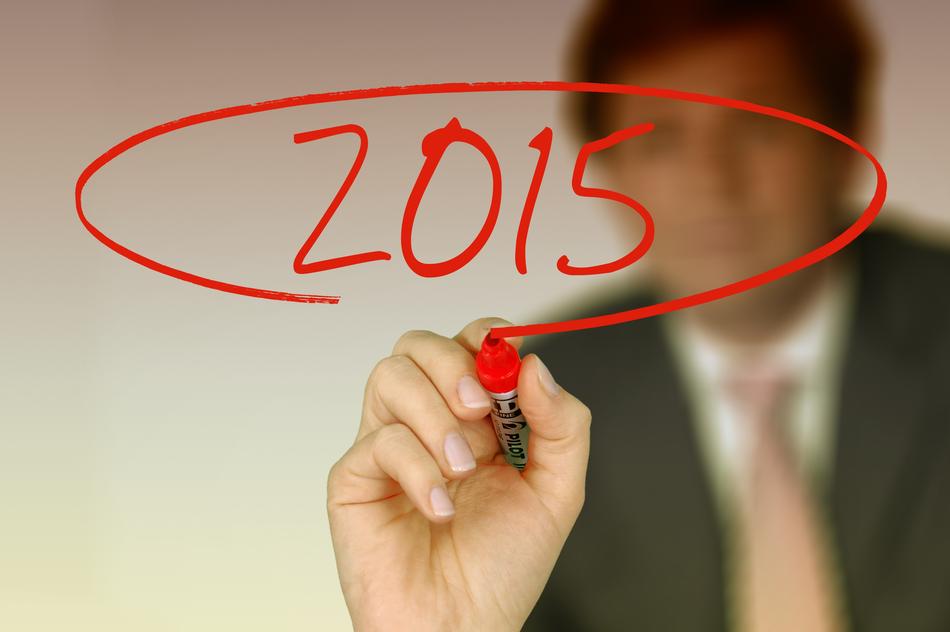 2015 on blackboard businessman on blurred background