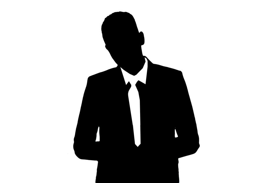 Black and white silhouette of the man, in the suit, with the tie, at white background, clipart