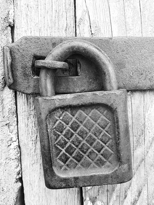 monochrome photo of lock on door