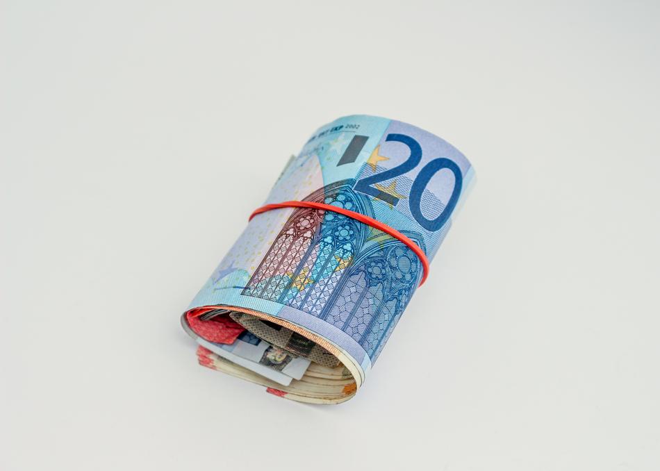 Colorful Euro banknotes in the red rubber band
