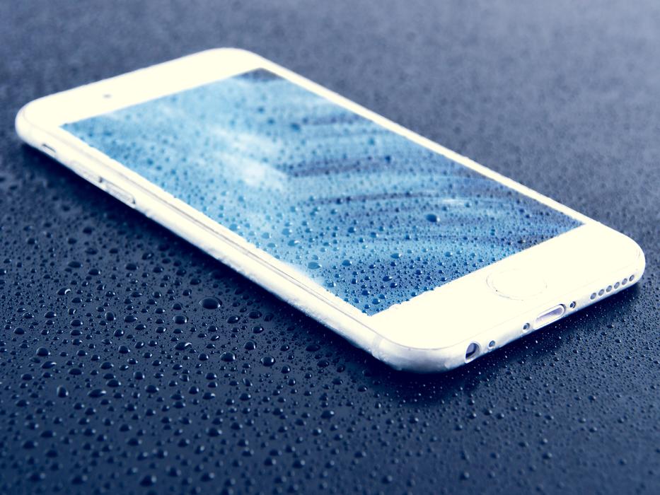 Close-up of the beautiful, shiny Iphone 6S with the water drops on the screen
