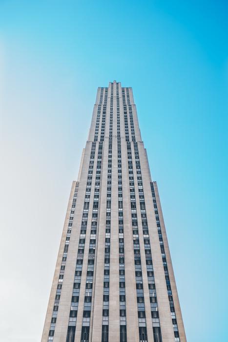 grey concrete Skyscraper at blue sky