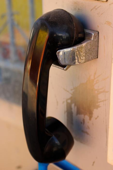black telephone receiver on the street close up