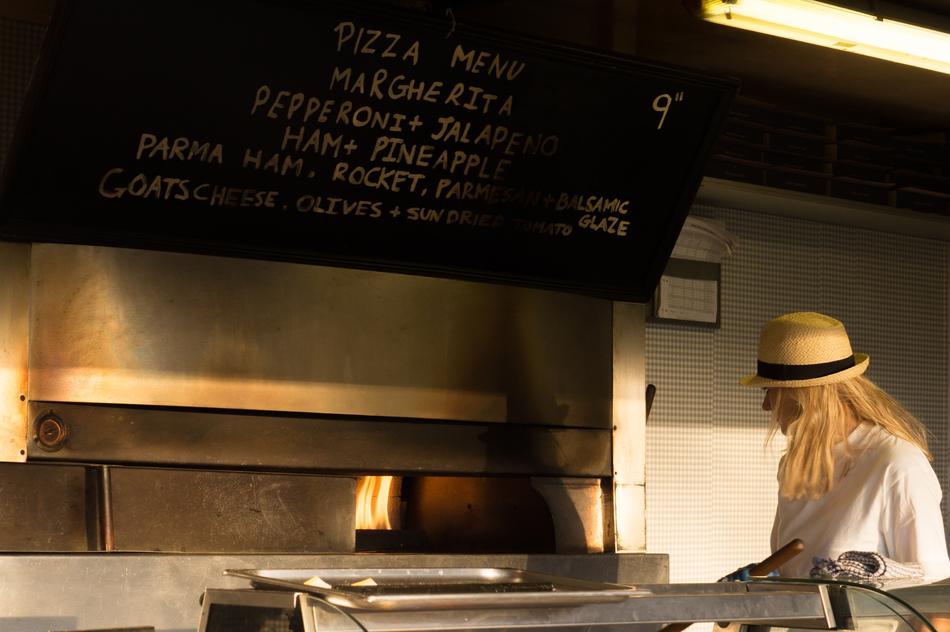 photo of a girl in a hat in an italian pizzeria