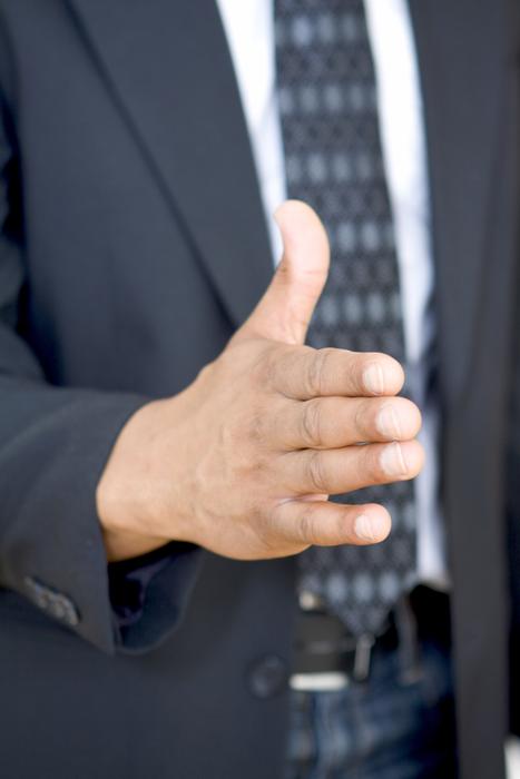 Man in suit, with the tie, showing hand