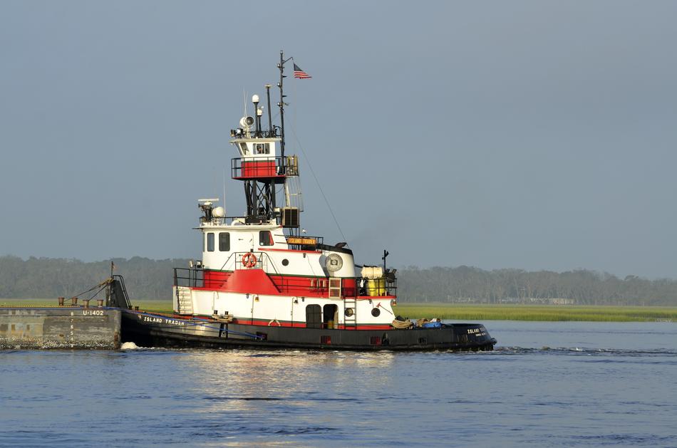 Tug Towing Barge along coastline